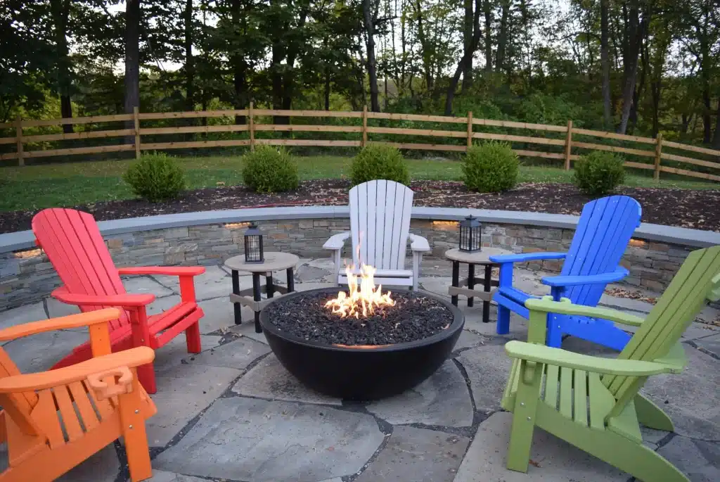 stone patio with colorful chairs and firepit
